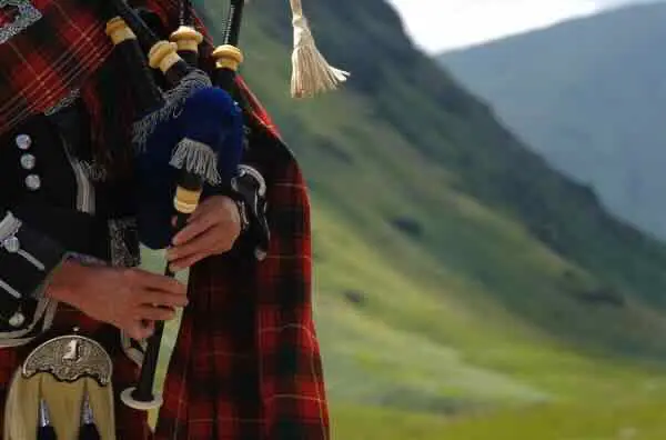Bagpiper in a Highland landscape